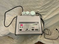 Full view of Prido UK-230 facial machine showing body, control panel with buttons, timer display, and cords.