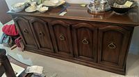 Front view of the Drexel wooden server showing six cabinet doors with metal ring pull handles
