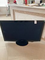 Front view of the Panasonic plasma TV showing the screen and bezel on black circular stand.
