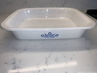 Side view showing Cornflower Blue floral pattern and shape of white ceramic baking pan.