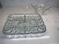 Rectangular heavy glass divided luncheon or relish tray and a small footed glass bowl with triangular shape and smooth finish