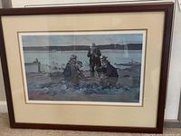 Framed 'Shore Dinner' limited edition art print showing four men at the shore enjoying a meal, framed white matte border and dark wood frame.