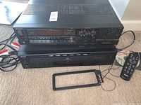 Front top down view of Technics SA-160 receiver and Aiwa CD changer with remote and antenna visible