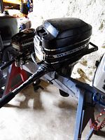 Side view of Mercury 6 HP outboard motor mounted on stand