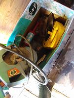 Top-down view of the box showing circular saw, extension cord, and various hand tools