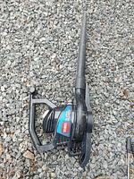 Side view of Toro electric leaf blower showing the main body, handle, and nozzle attachment.
