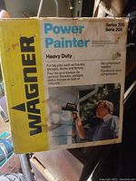 Original yellow box with Wagner branding and product information on the front including model Series 200, no compressor needed, and use cases.