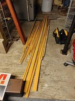 Long shot of the wooden trim pieces laid on the floor showing the length and variety of sizes.