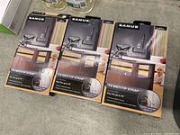 Three packages of SANUS TV Anti-Tip Straps with packaging visible, for securing TVs up to 70 inches.