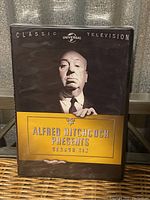 Front cover of Alfred Hitchcock Presents Season Six DVD with classic portrait and title.