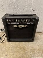Front view of Behringer V-Tone GM108 guitar amplifier showing control panel and logo on grille cloth