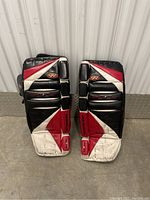 Front view of pair of Hespeler ice hockey goalie pads showing wear and color pattern