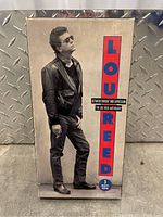 Front view of the Lou Reed anthology box set with image of Lou Reed on the cover and title text in red and blue.