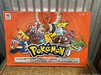 Front of the Pokémon Master Trainer board game box showing colorful Pokémon character artwork and branding