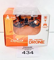 Front view of the Cobra R/C micro drone in orange and white packaging with clear plastic window showing drone inside.