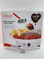 Front of the product box showing the fondue pot filled with chocolate and fondue forks, with fruit and bread for dipping.