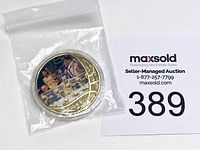 Kobe Bryant commemorative coin sealed in a small plastic bag next to a MaxSold auction card.