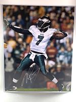 Signed Michael Vick 16x20 photo showing action pose in Eagles uniform with visible silver signature