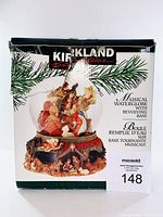 Box of Kirkland musical waterglobe with revolving base showing the product image and branding.