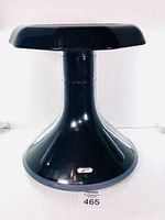 Front view of black SitWell Wobble Stool showing flared base and logo on base.