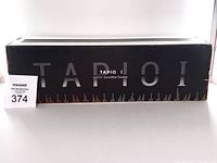 Box front showing TAPIO 1 2.0CH Soundbar System branding in black and white box.