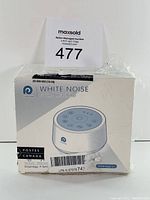 White noise machine in original box with seller's auction tag on top.
