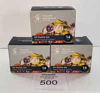 Front view showing three boxes of Yellow Mountain Imports marbles, each labeled with 60 marble set, petal style 6 colors, 14 mm size.