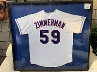 Framed white Zimmerman jersey with blue and red stitched number 59, signed on the number 5.