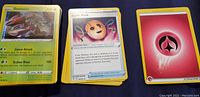 Stack of Pokemon cards showing Genesect card at front with Trainer and Energy cards to the right.