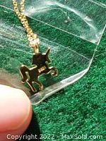 Close-up image showing the gold toned unicorn pendant with .925 marking on the back.