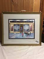 Full view of the framed Bistro de Paris print by Sandi Lebron, showing the artwork under glass with double matting in a gold frame.
