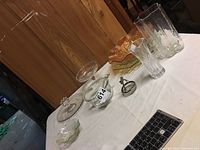 Full view of all items on table including various Candlewick pieces and carnival glass bowl