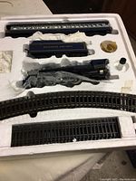 Styrofoam tray showing locomotive, tender, small parts and track sections