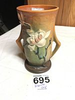 Front view of Roseville Mold 89-7 vase showing floral design, orange and green glaze, and two handles.