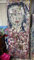 Full view of wooden door painted with abstract portrait featuring red lips, black and white brushstrokes, and layered colors.