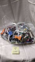 Clear plastic bag filled with assorted LEGO bricks, showing the variety in colors and types of pieces.