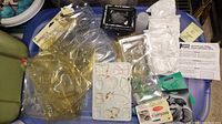 Overview of the lot showing multiple clear plastic molds, multi-shape mold, plaster bags, and instruction sheets.