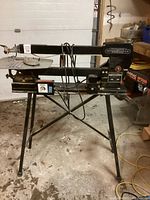 Full view of the Excalibur scroll saw mounted on its folding stand