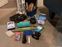 Photo showing assortment of health and fitness items including adjustable dumbbell, scale, and massage aids.
