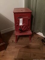 Front view of red cast iron stove with closed door