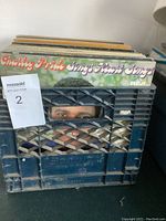 View of multiple LP albums in blue plastic crate, prominently showing Charley Pride 'Sings Heart Songs' album.