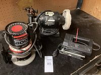 Craftsman 600 router, bench grinder with buffing wheel, and Black & Decker basic jig saw on black tabletop.