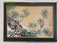 Framed Asian print showing the snow covered pine tree branch, the green mat, and wood frame with dimensions label.