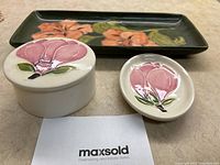 Photo of all three Moorcroft pottery dressing table pieces showing floral designs and condition