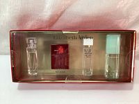 Full view of Elizabeth Arden gift set in original packaging showing four small scent spray bottles.