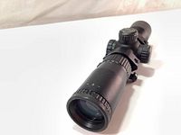 Side angled view of the Excalibur Tact 100 crossbow scope showing lens and zoom ring.