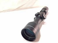 Angled close-up of Excalibur Twilight DLX crossbow scope showing front lens and body.