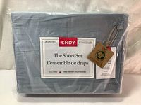 Packaged bed sheet set with label showing brand, size, and thread count.
