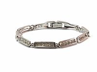 Full view of the silver-tone Swarovski tennis bracelet showing rectangular links with embedded clear crystals and clasp engraved Swarovski.