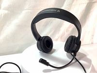 Front angle view of the black Thronmax THX-20 headset showing adjustable headband, ear cushions, and boom microphone.